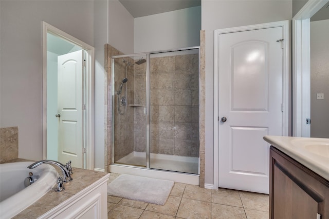 bathroom featuring plus walk in shower, vanity, and tile patterned floors