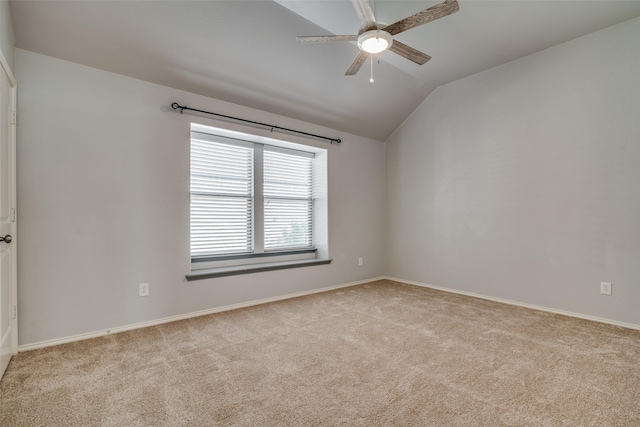 empty room with ceiling fan, light colored carpet, and lofted ceiling