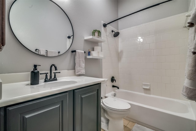 full bathroom featuring toilet, vanity, tile patterned floors, and tiled shower / bath