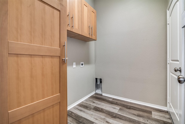 clothes washing area with cabinets, dark hardwood / wood-style floors, and electric dryer hookup