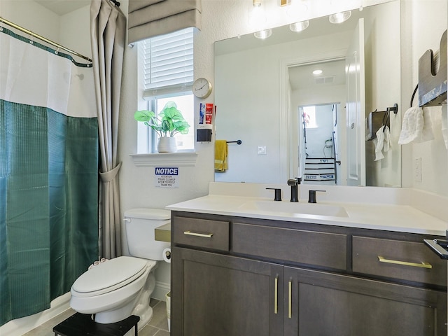 bathroom with vanity, tile patterned floors, and toilet