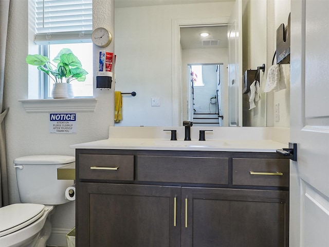 bathroom featuring vanity and toilet