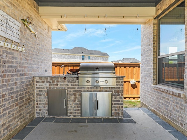 view of patio with area for grilling, exterior kitchen, and sink