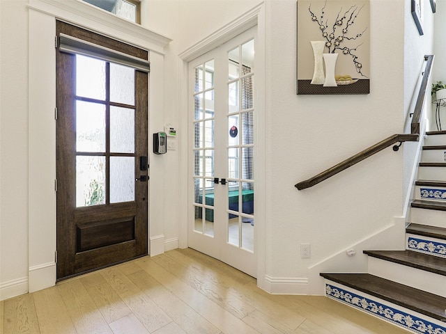 foyer with light hardwood / wood-style floors and a wealth of natural light