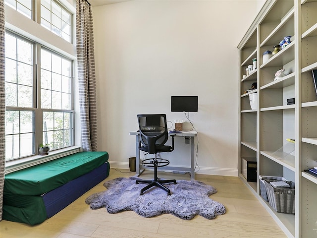 office area with plenty of natural light and light wood-type flooring