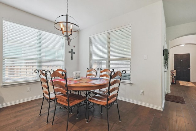 dining area featuring dark hardwood / wood-style floors and a notable chandelier