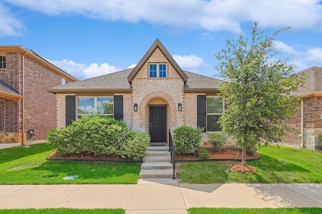 tudor-style house with a front lawn