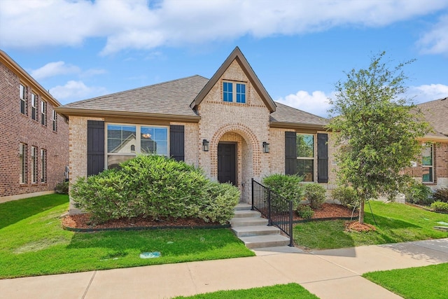 2133 Miramar Dr, Little Elm, TX 75068 - view of front of home with brick siding, a front yard, and a shingled roof