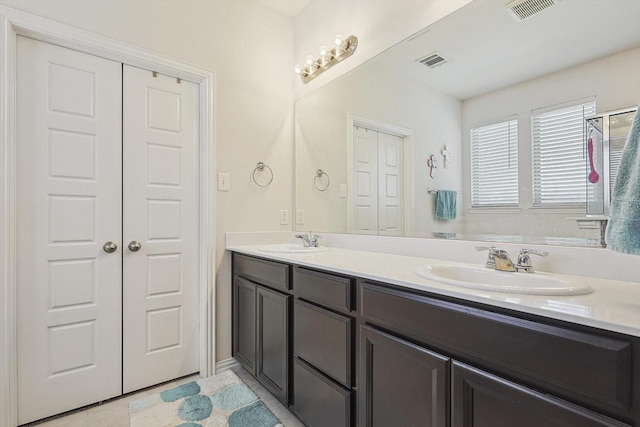 bathroom with tile patterned floors and vanity