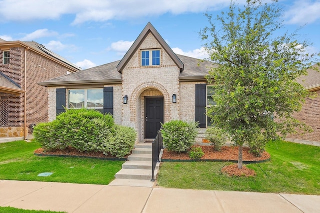 2133 Miramar Dr, Little Elm, TX 75068 - view of front of home featuring brick siding, a front lawn, and roof with shingles