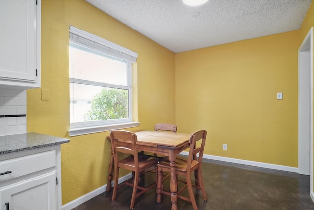 dining space featuring a textured ceiling