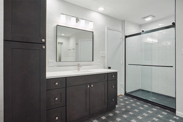 bathroom with vanity and a shower with door