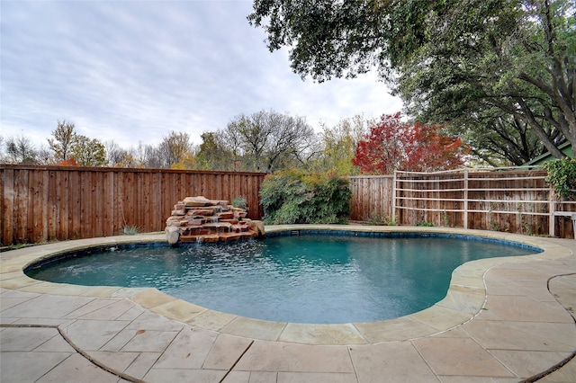 view of swimming pool with a patio area and pool water feature