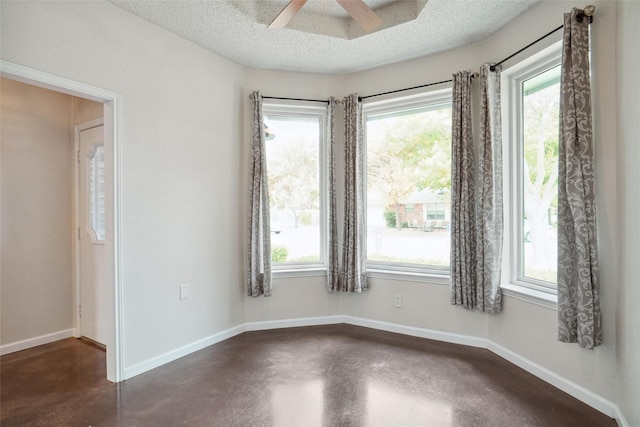 unfurnished room with a textured ceiling