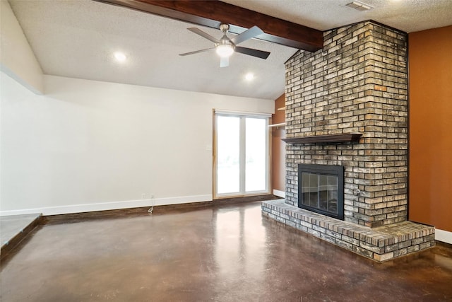 unfurnished living room featuring lofted ceiling with beams, concrete floors, ceiling fan, a brick fireplace, and a textured ceiling