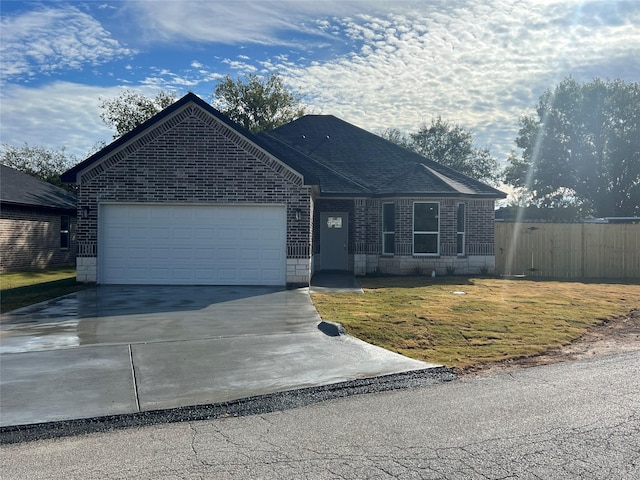 single story home with a front yard and a garage