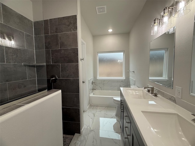 full bathroom with vanity, shower with separate bathtub, and toilet