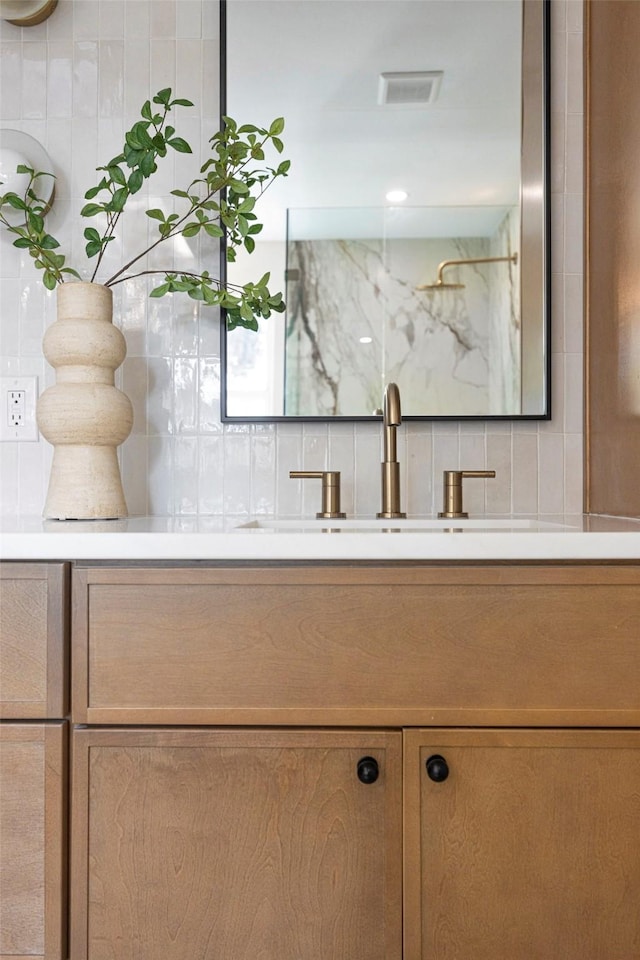 bathroom with decorative backsplash and vanity