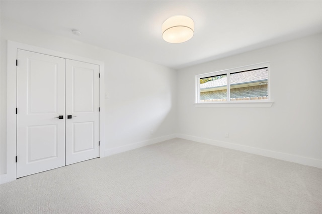 unfurnished bedroom with carpet flooring and a closet