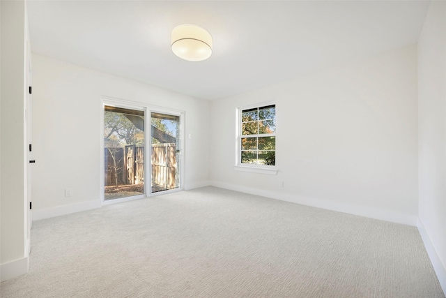 carpeted empty room featuring a healthy amount of sunlight