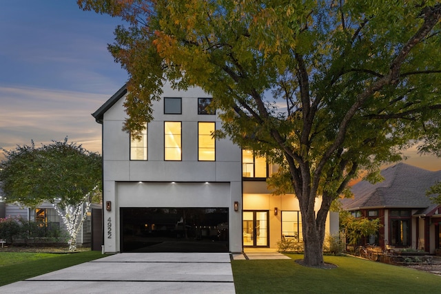 view of front of house with a yard, french doors, and a garage