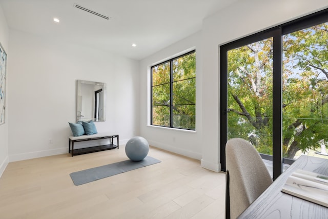 workout area with light wood-type flooring