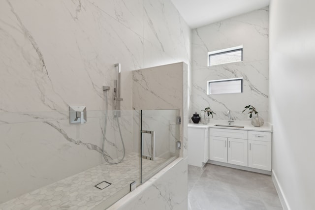 bathroom featuring a tile shower and vanity