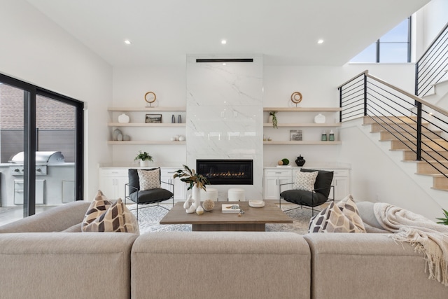 living room with a high end fireplace