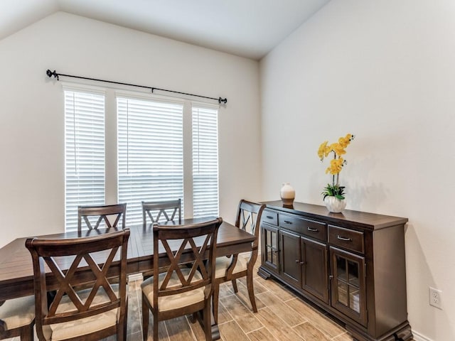 dining space with lofted ceiling