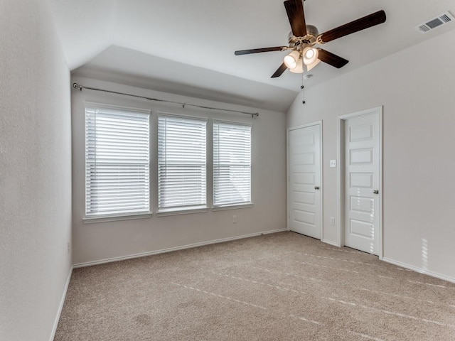 unfurnished bedroom with lofted ceiling, light colored carpet, and ceiling fan