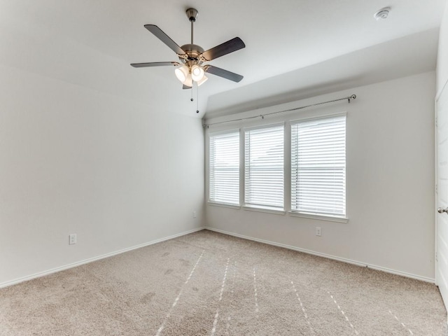 carpeted empty room featuring ceiling fan