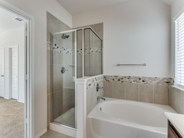 bathroom with independent shower and bath and vanity