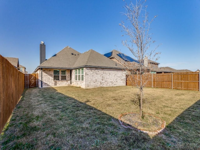 rear view of property with a yard