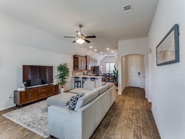 living room featuring ceiling fan, dark hardwood / wood-style flooring, and lofted ceiling