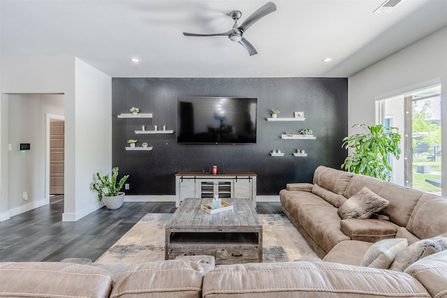 living room with ceiling fan and dark hardwood / wood-style flooring