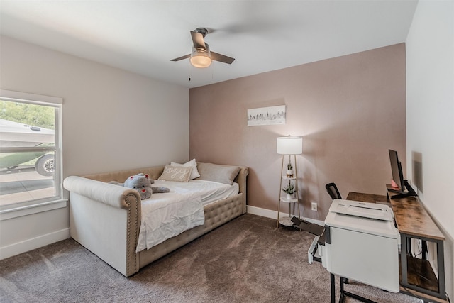 bedroom featuring ceiling fan and dark carpet