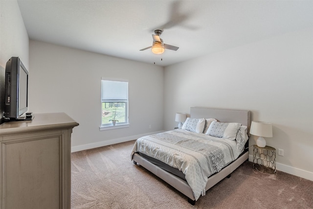 bedroom with dark colored carpet and ceiling fan