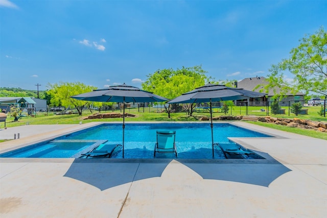 view of swimming pool featuring a patio area and a yard