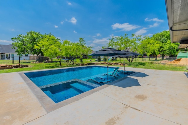 view of swimming pool with an in ground hot tub, a yard, and a patio