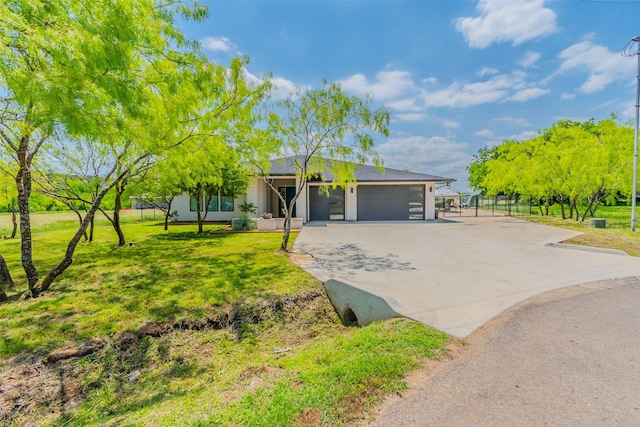 ranch-style home featuring a garage and a front lawn