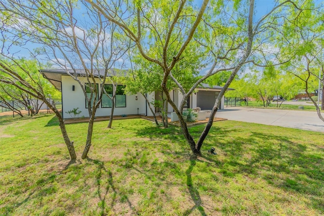 ranch-style home with a front lawn and a garage