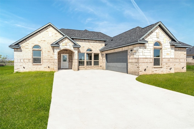 french provincial home featuring a garage and a front yard