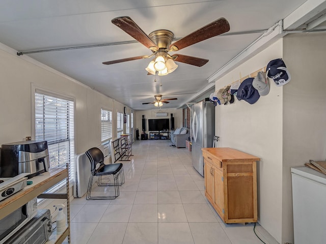 living room featuring crown molding, ceiling fan, and light tile patterned floors