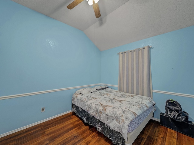 bedroom featuring lofted ceiling, dark hardwood / wood-style flooring, and ceiling fan