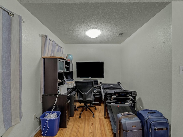 office space featuring hardwood / wood-style floors and a textured ceiling