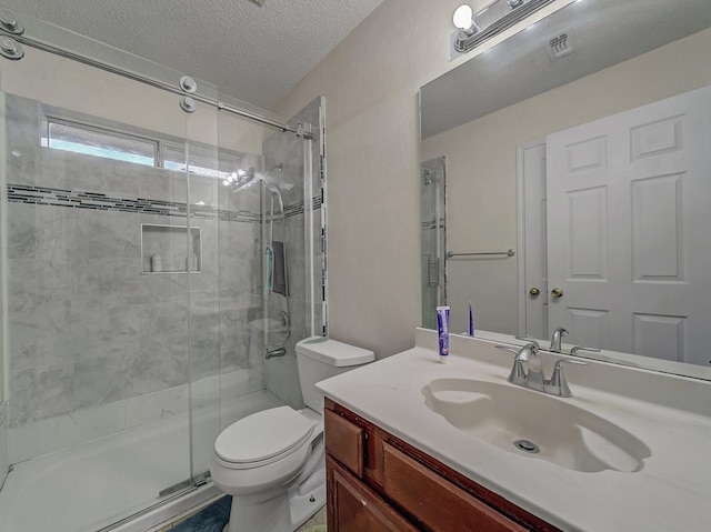 bathroom featuring vanity, an enclosed shower, a textured ceiling, and toilet