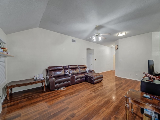 living room featuring dark hardwood / wood-style flooring, vaulted ceiling, and a textured ceiling