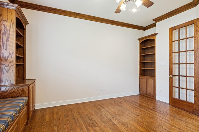 interior space featuring hardwood / wood-style flooring, ceiling fan, ornamental molding, and french doors