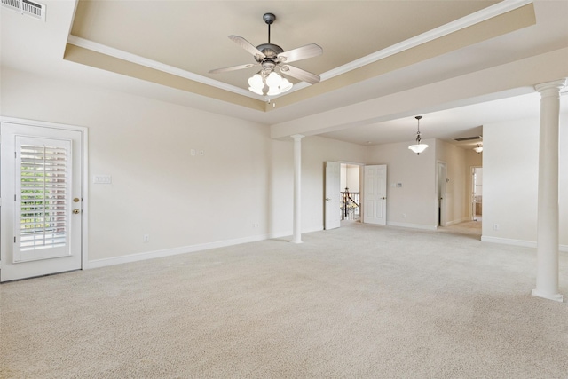 unfurnished living room featuring light carpet, a tray ceiling, ceiling fan, and decorative columns