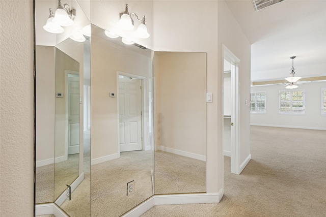 bathroom featuring ceiling fan with notable chandelier